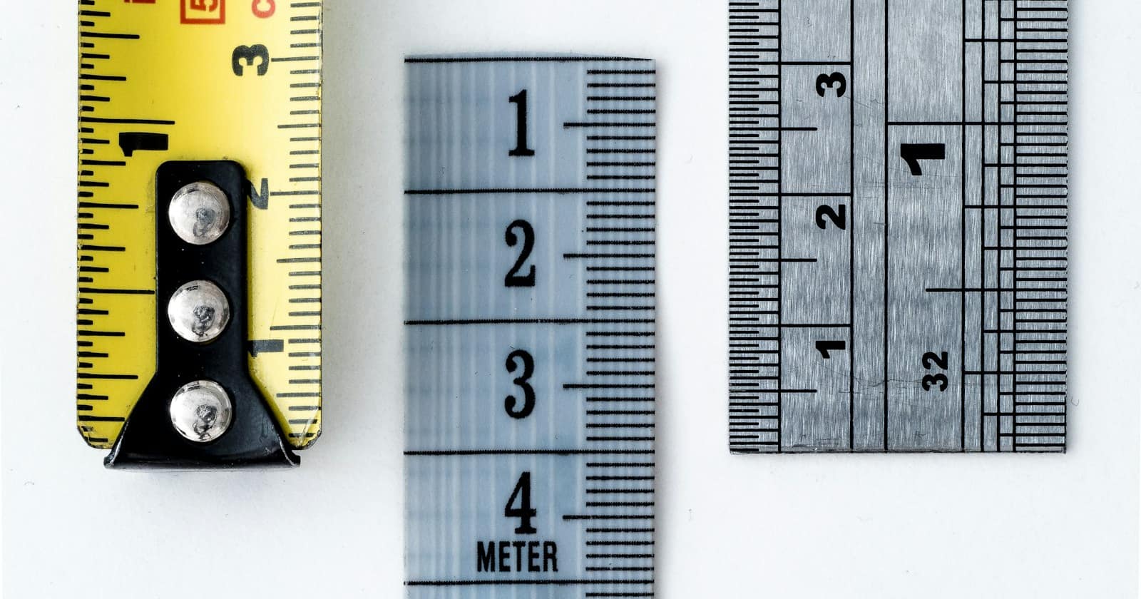 A tape measure and tools laid out on a surface